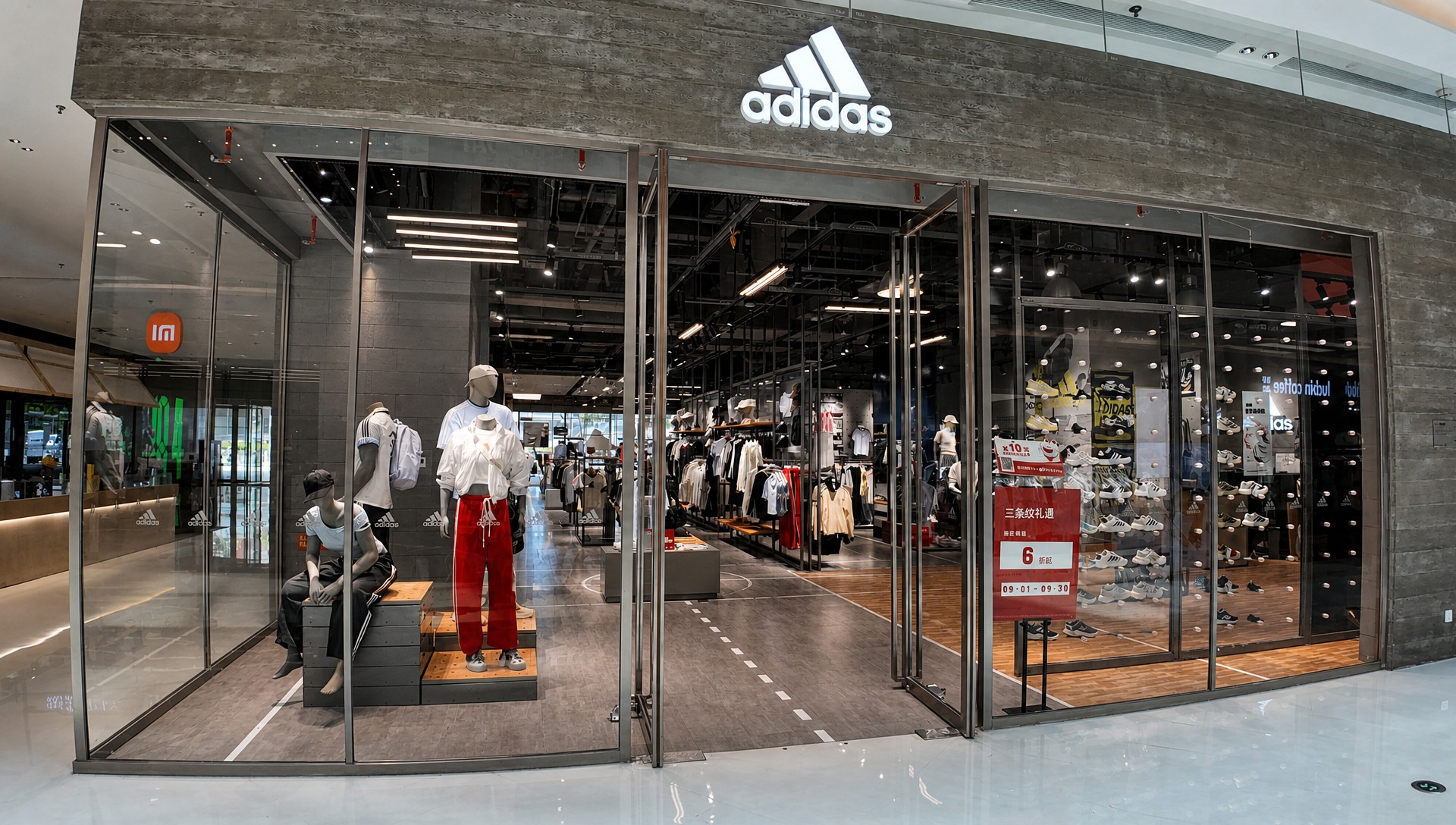 Sportswear brand storefront with glass facade and display windows